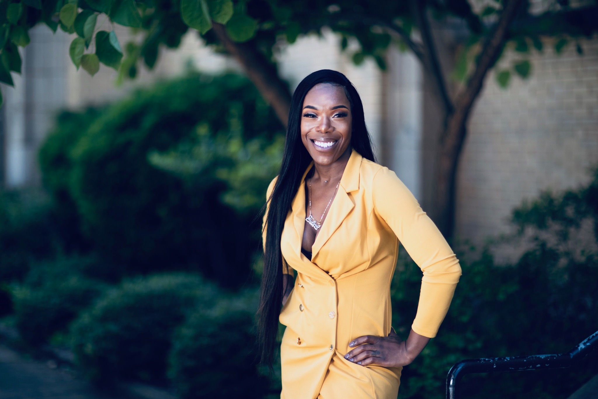 Eisha Love wearing a yellow suit outdoors
