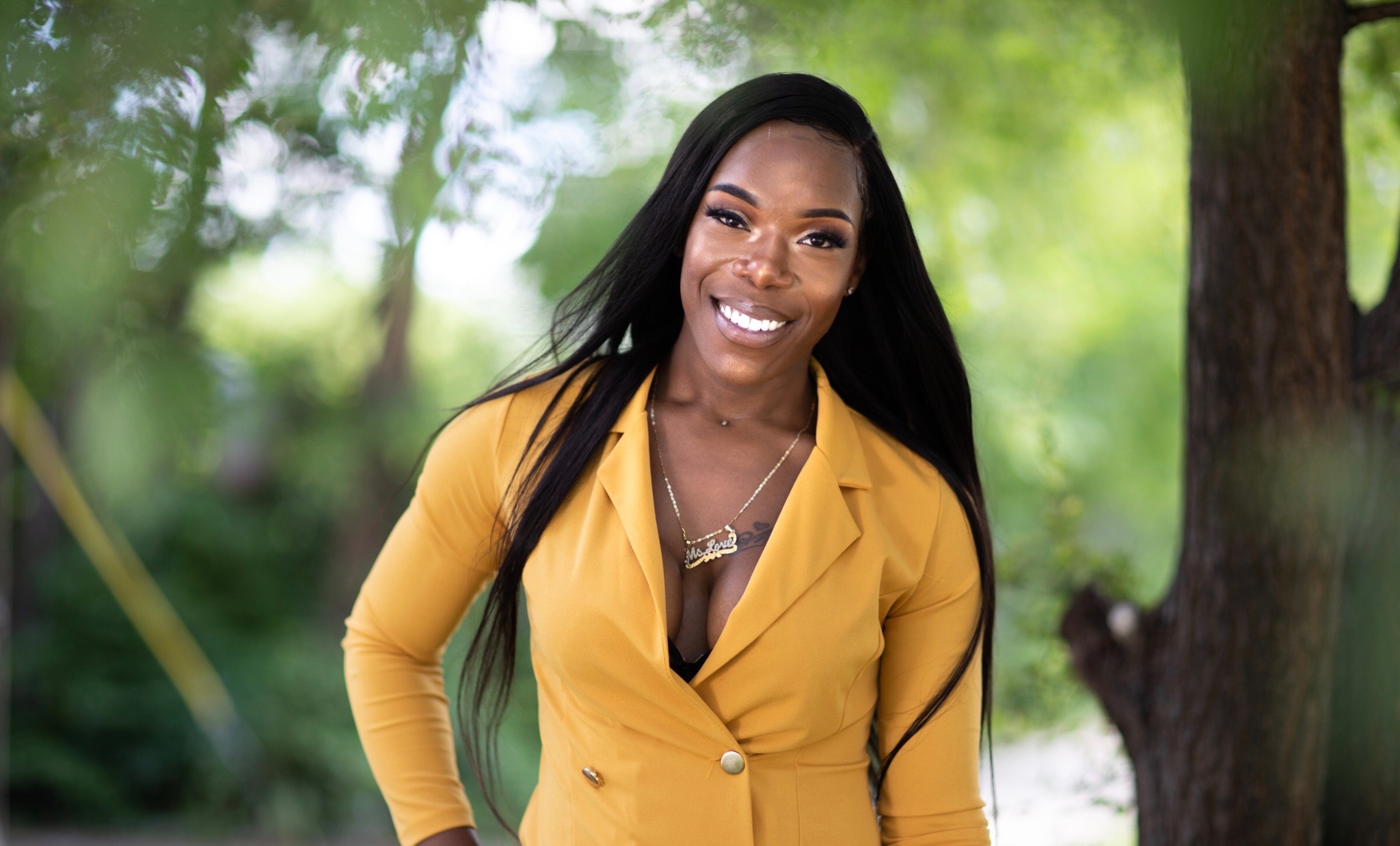 Eisha Love in a yellow suit outdoors
